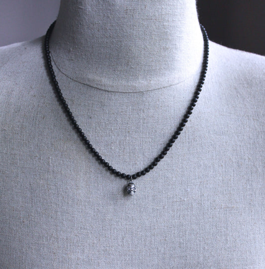 men's small silver skull pendant on beaded necklace
