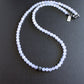 A necklace with a string of white agate beads and a large eagle eye focal bead, finished with an oxidized sterling silver lobster clasp.