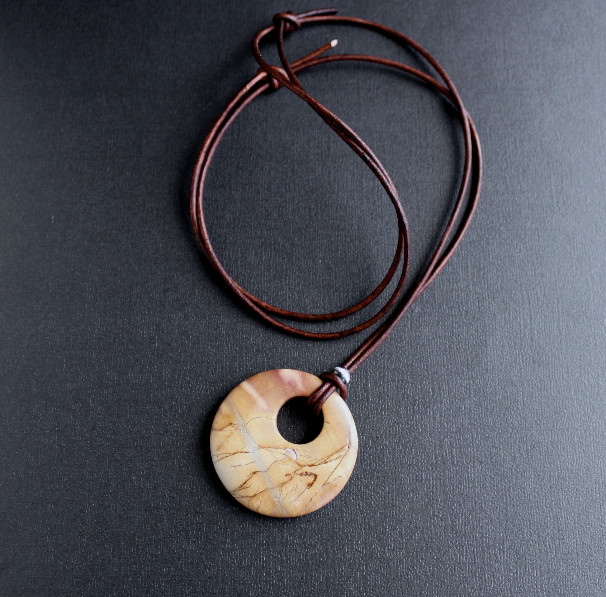 large round stone pendant on leather cord