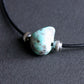 large campitos turquoise stone on leather cord