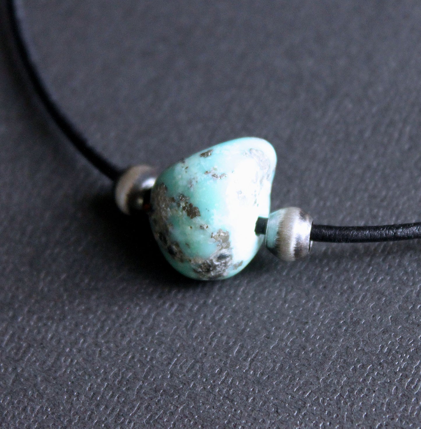 large campitos turquoise stone on leather cord