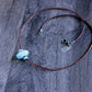 large turquoise bead on leather cord