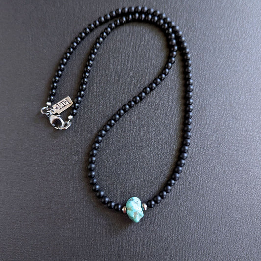 Black beaded necklace with a turquoise stone 