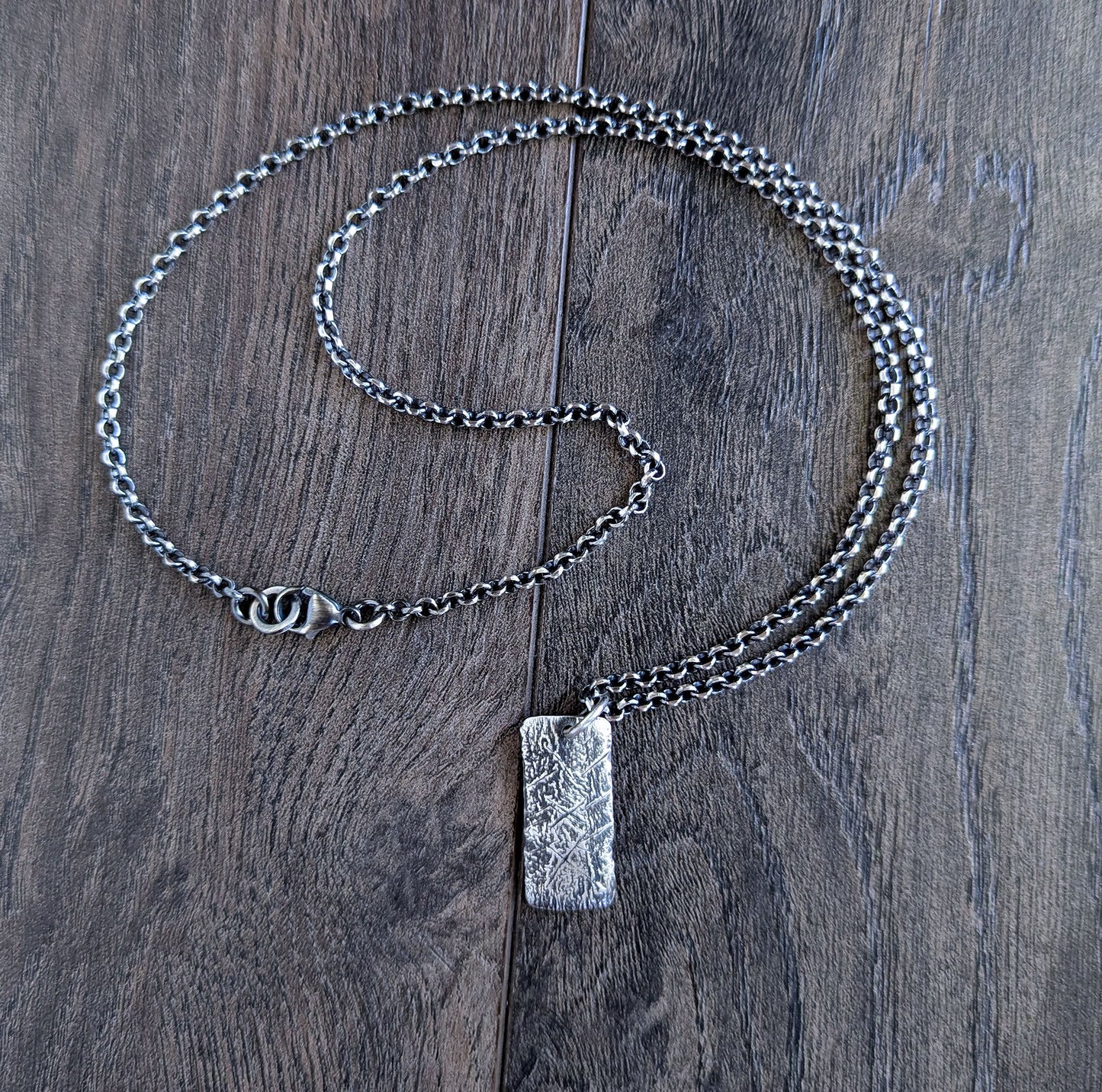 Silver chain necklace with a rustic silver rectangular pendant 