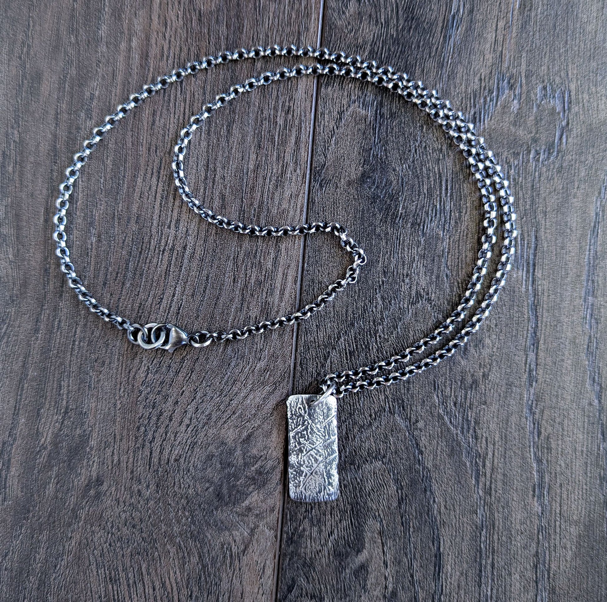 Silver chain necklace with a rustic silver rectangular pendant 