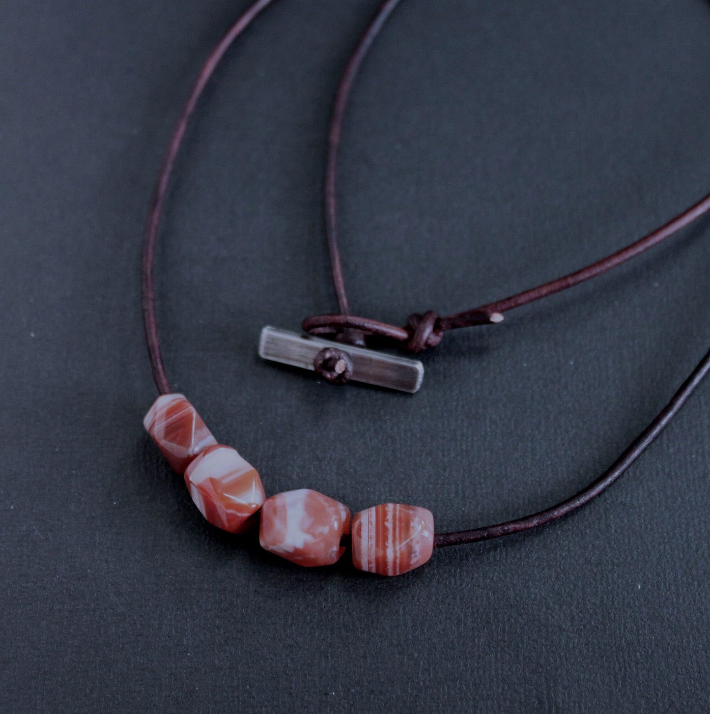 orange banded agate beads on leather cord