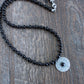 polished black bead necklace with sterling silver pendant