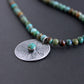 hand stamped silver pendant on turquoise bead necklace