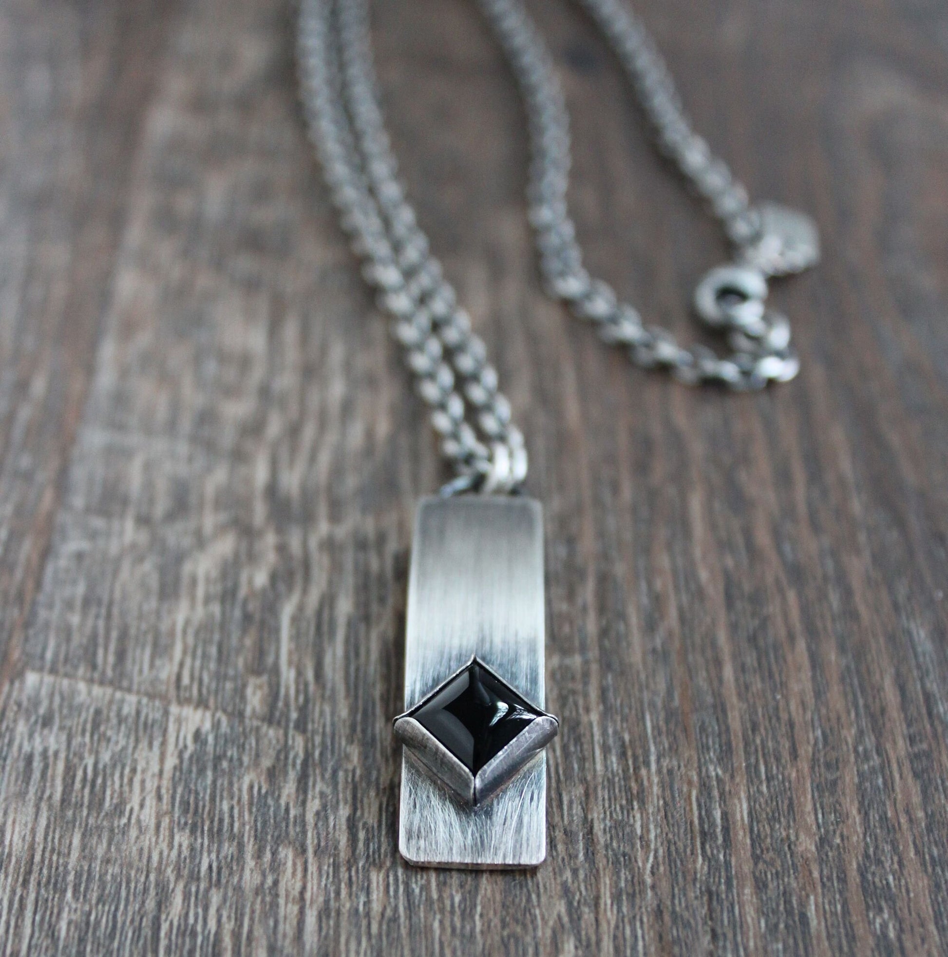 long silver pendant with onyx stone